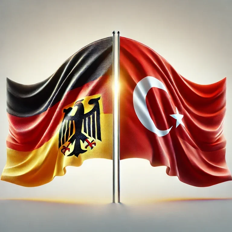 Flaggen von Deutschland und der Türkei, gekreuzt und in warmem Licht beleuchtet.